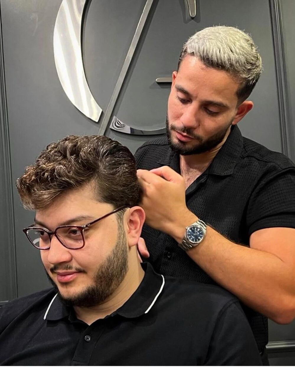 The barber at work, styling a client's hair